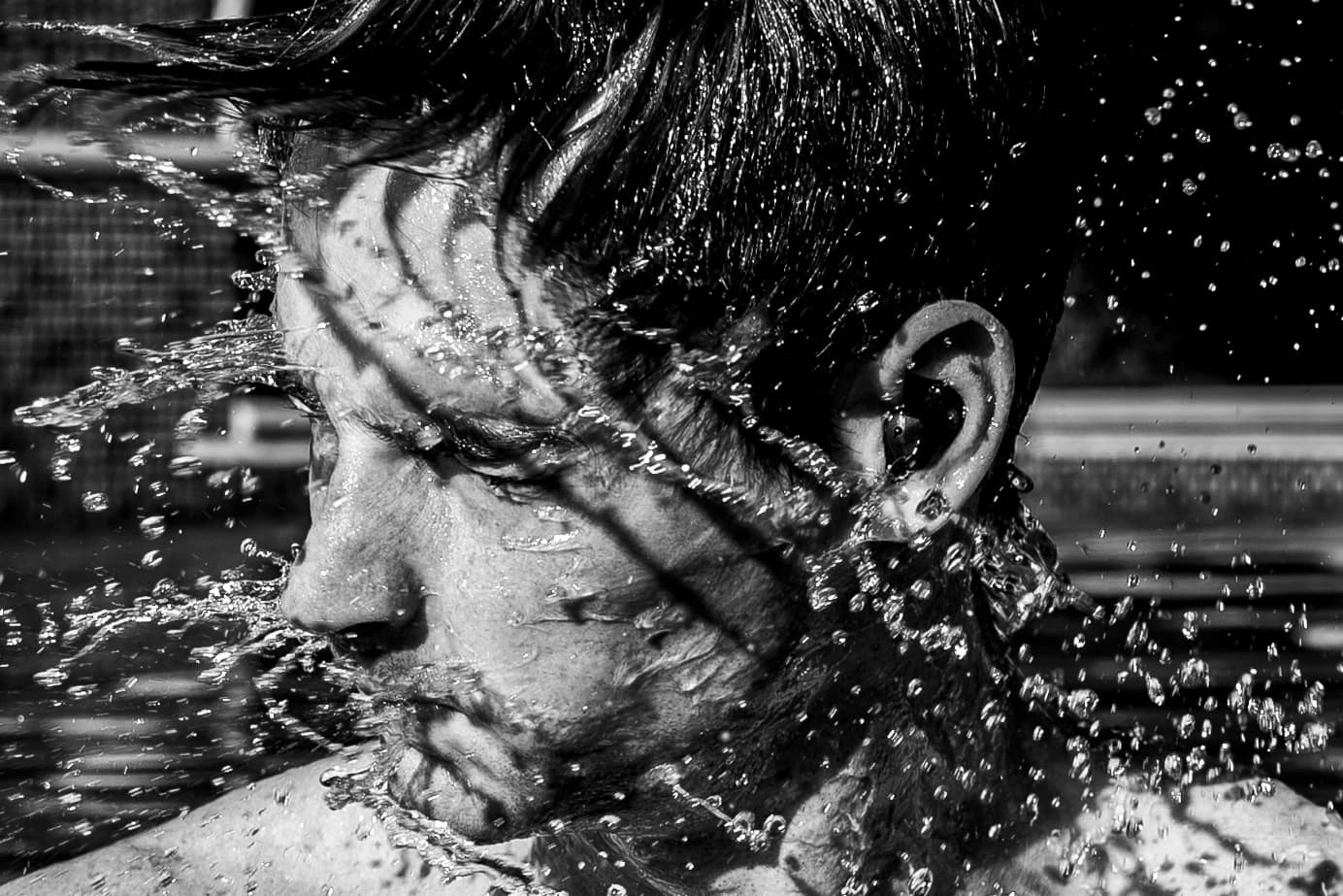 A swimmer surfacing, the bud in his ear