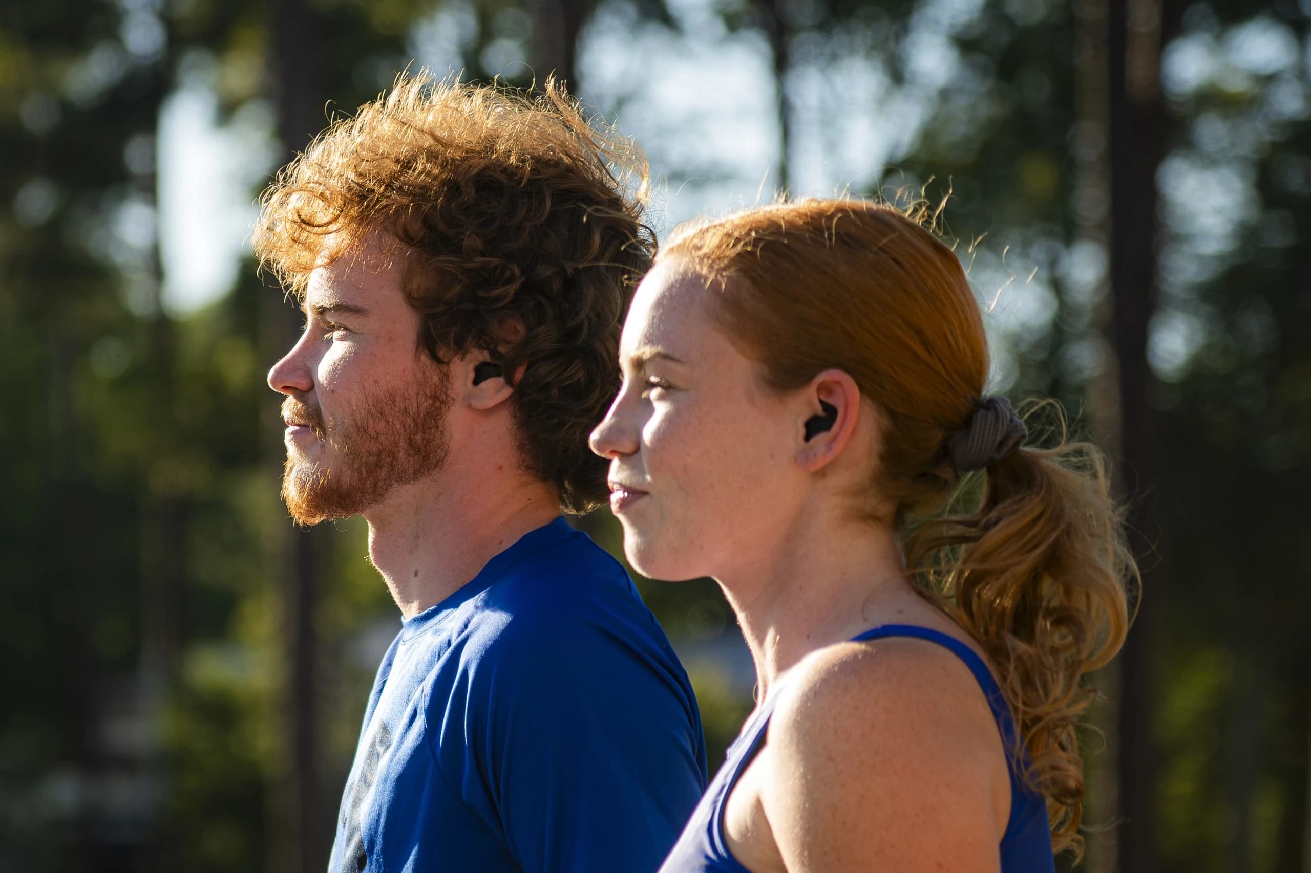 Two runners side by side, buds in